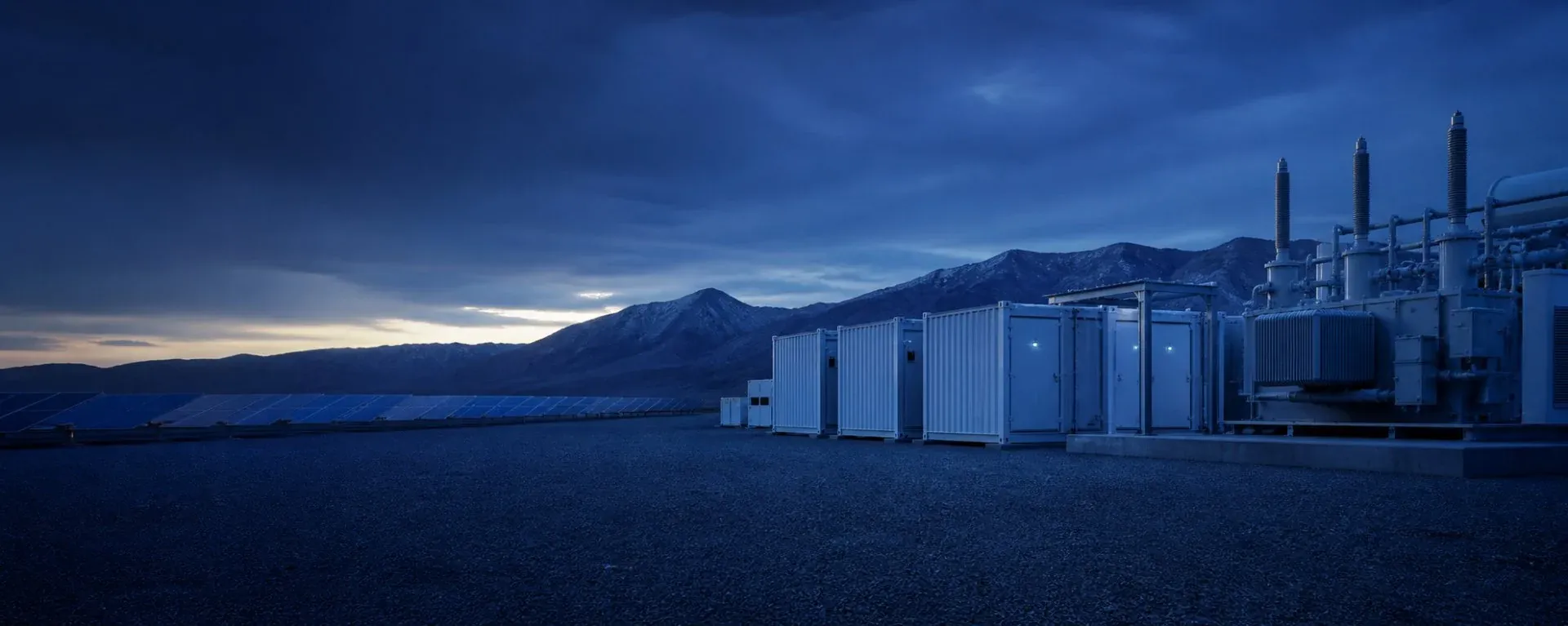 Project-scale battery energy storage containers and transformer equipment at a solar site.